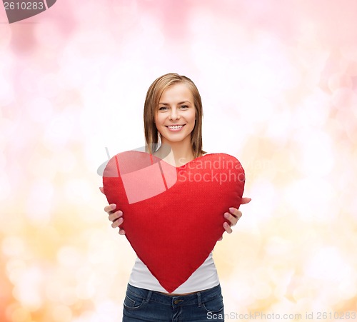 Image of smiling woman in white t-shirt with heart