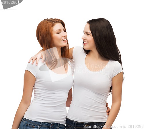 Image of two laughing girls in white t-shirts hugging