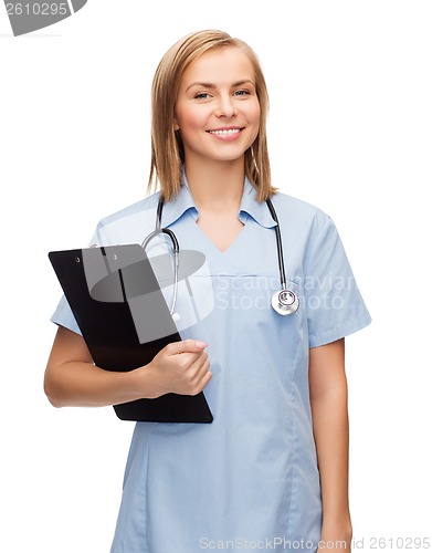 Image of smiling female doctor or nurse with clipboard