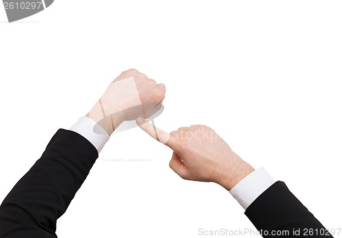 Image of businessman pointing to something at his hand