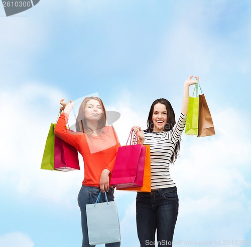 Image of two smiling teenage girls with shopping bags