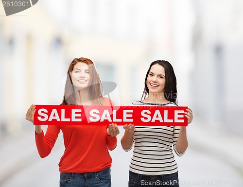 Image of two smiling teenage girl with percent sign on box
