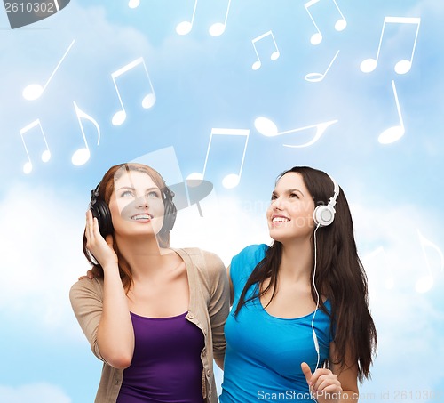 Image of two smiling teenagers with headphones