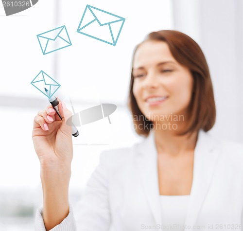 Image of businesswoman drawing envelopes in the air