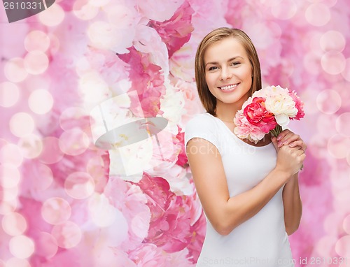 Image of smiling woman with bouquet of flowers