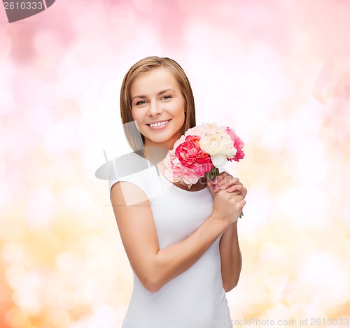 Image of smiling woman with bouquet of flowers