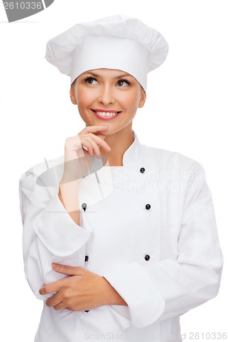 Image of smiling female chef dreaming