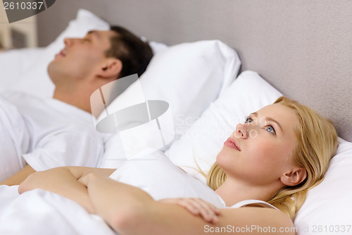 Image of happy couple sleeping in bed