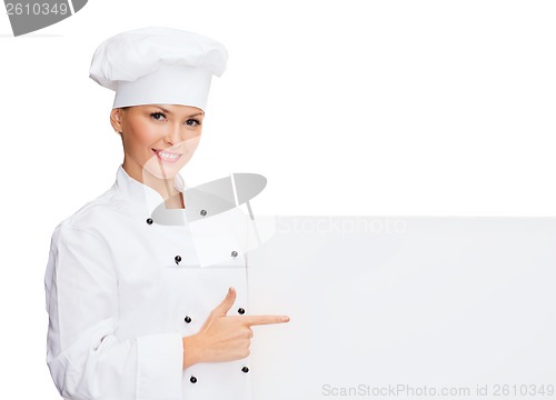 Image of smiling female chef with white blank board