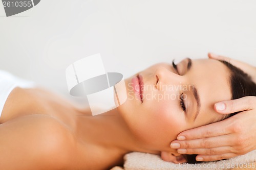 Image of beautiful woman in spa salon having facial