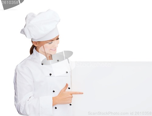 Image of smiling female chef with white blank board