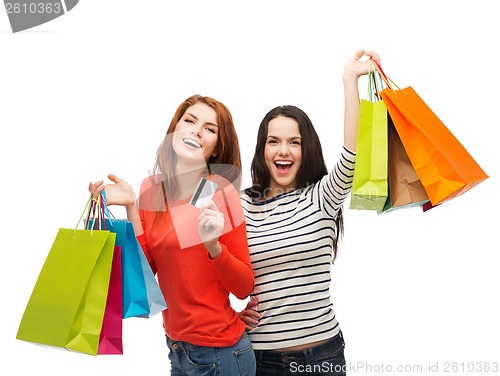 Image of teenage girls with shopping bags and credit card