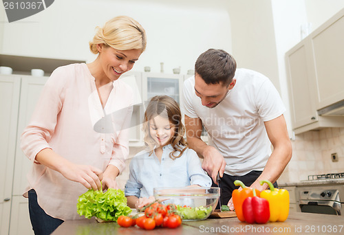 Image of happy family making dinner in kitchen