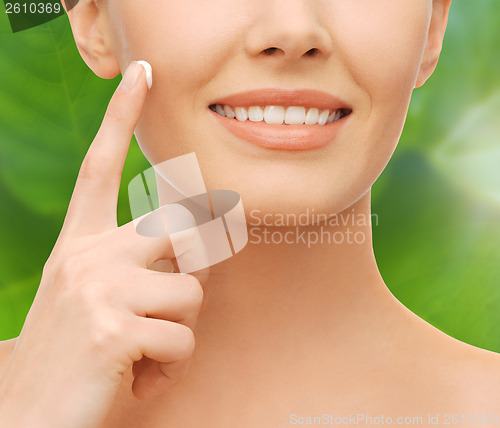 Image of closeup of woman hand applying moisturizing cream