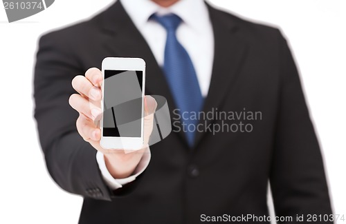 Image of businessman showing smartphone with blank screen