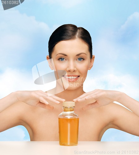 Image of beautiful woman with oil bottle