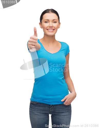 Image of smiling girl in blue t-shirt showing thumbs up