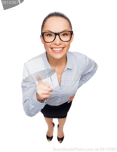 Image of smiling businesswoman with finger up