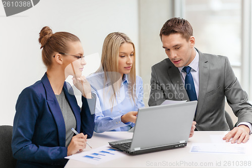 Image of business team with laptop having discussion
