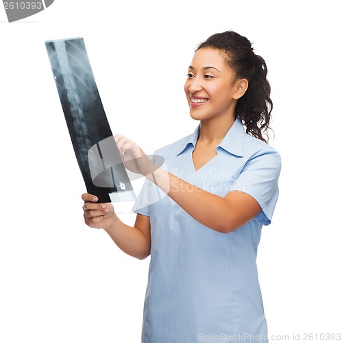 Image of smiling female doctor or nurse looking at x-ray