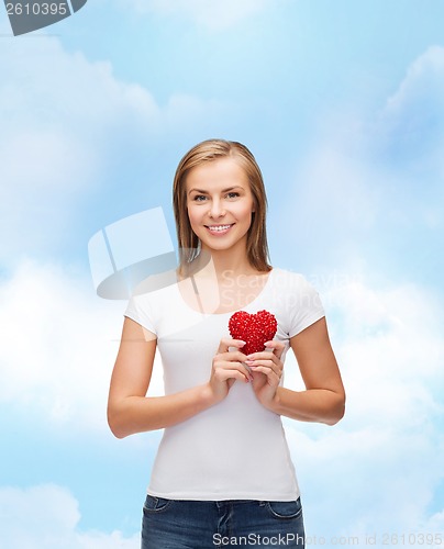 Image of smiling woman in white t-shirt with heart