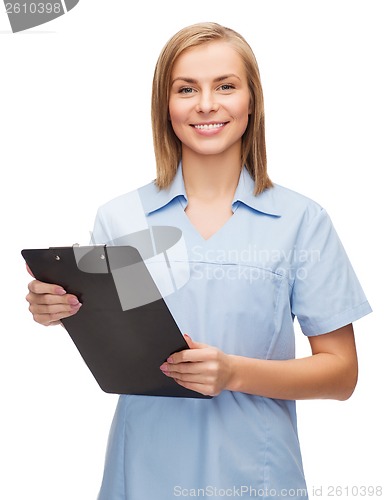 Image of smiling female doctor or nurse with clipboard