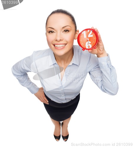 Image of smiling businesswoman with red clock