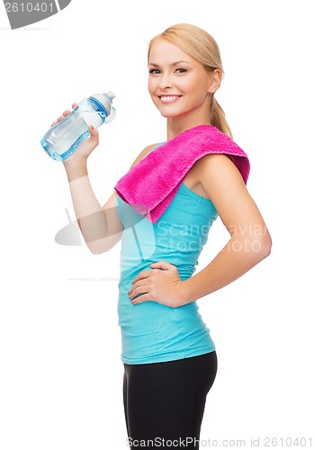 Image of sporty woman with towel and watel bottle