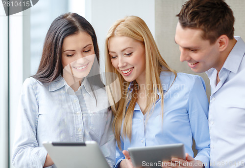 Image of business team working with tablet pcs in office