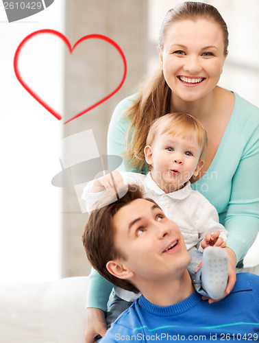 Image of happy parents playing with adorable baby