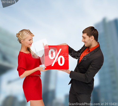 Image of smiling woman and man with red percent sale sign