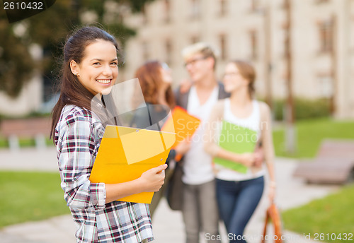 Image of teenage girl with folders and mates on the back