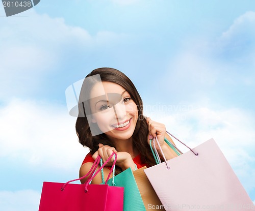 Image of woman in red dress with shopping bags