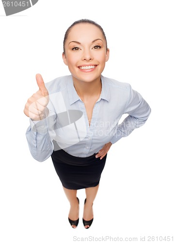 Image of smiling asian businesswoman showing thumbs up