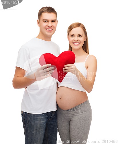 Image of happy young family expecting child with big heart