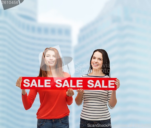 Image of two smiling teenage girl with percent sign on box