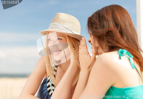 Image of girls gossiping in cafe on the beach