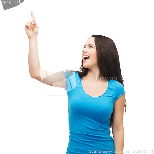 Image of smiling teenager pointing her finger up