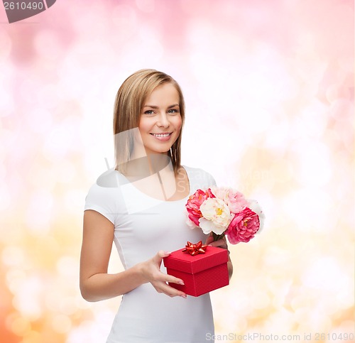 Image of smiling woman with bouquet of flowers and gift box
