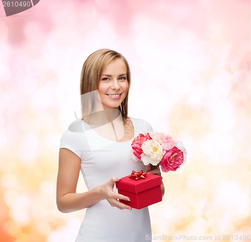 Image of smiling woman with bouquet of flowers and gift box