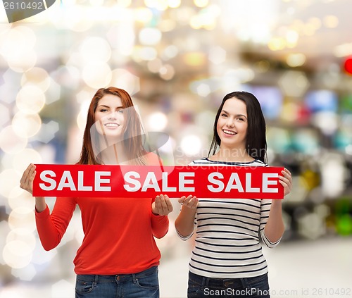 Image of two smiling teenage girl with percent sign on box