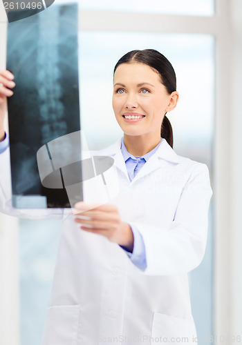 Image of smiling young doctor in cabinet