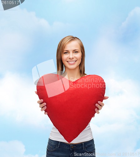 Image of smiling woman in white t-shirt with heart