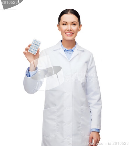 Image of smiling female doctor with pills