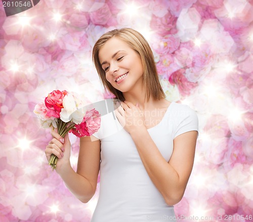 Image of smiling woman with bouquet of flowers