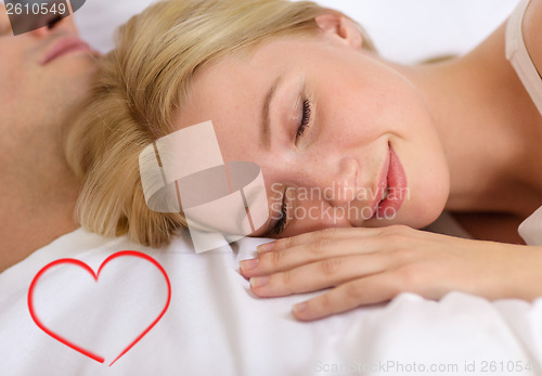 Image of happy couple sleeping in bed