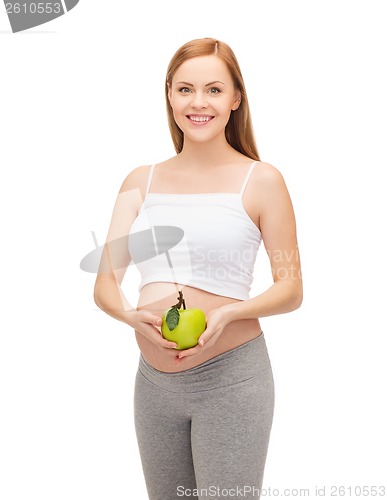 Image of happy future mother with green apple