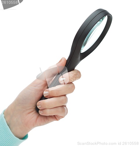 Image of woman hand holding magnifying glass