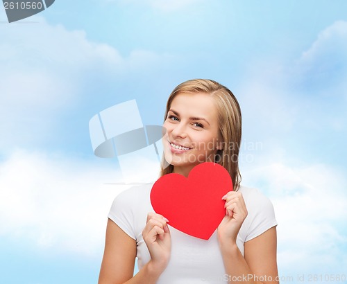 Image of smiling woman in white t-shirt with heart