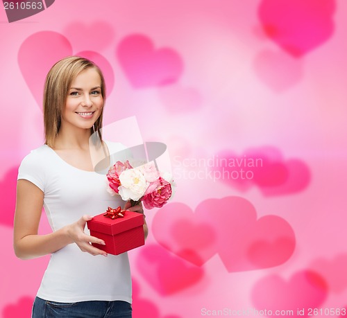 Image of smiling woman with bouquet of flowers and gift box